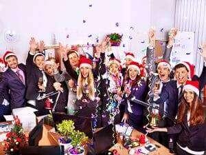 Happy group people in santa hat at Xmas business  party.